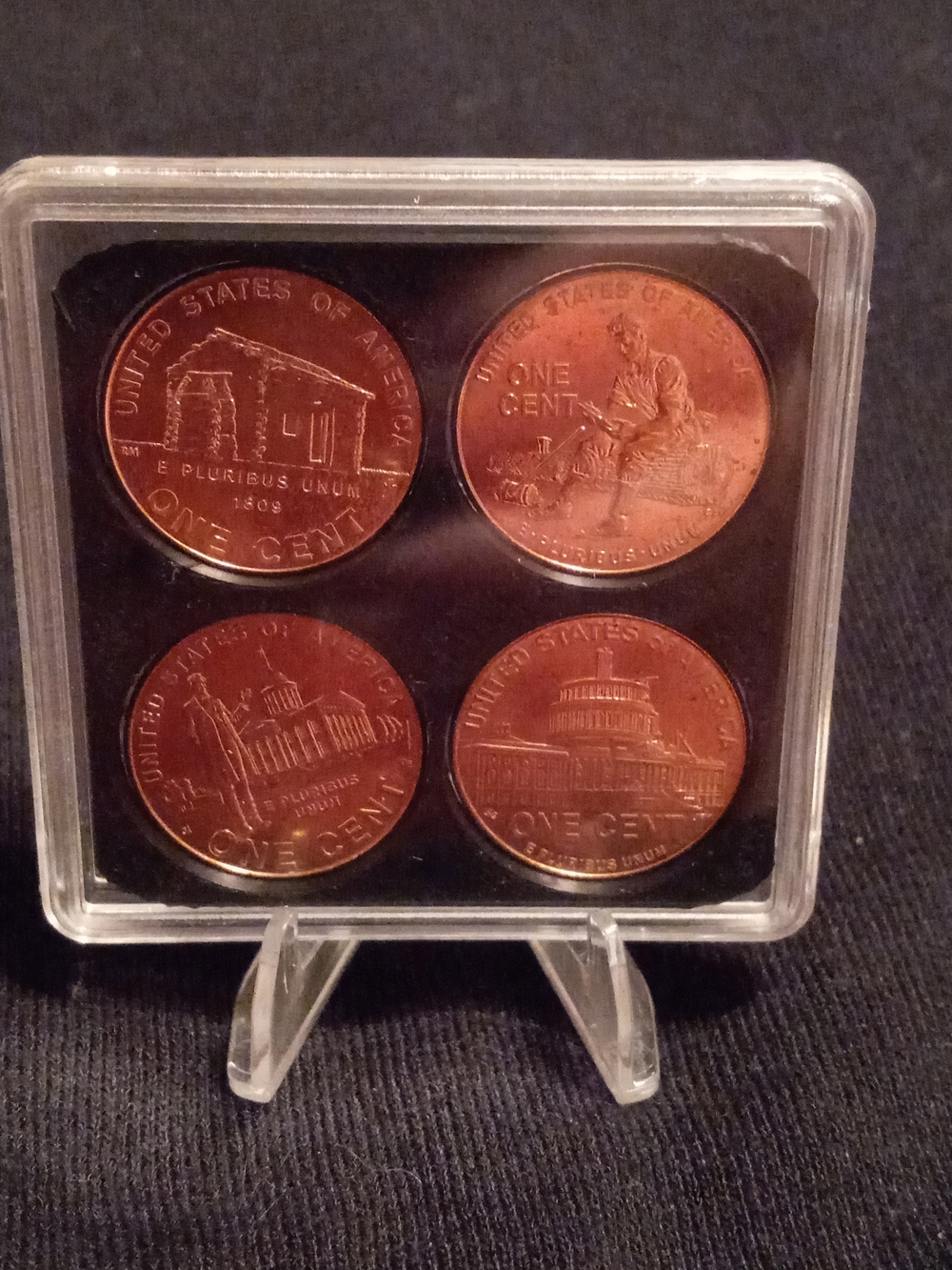 Set of Four 2009 D One Cent Collectible Coins. Plastic Case And Display Stand